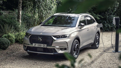 Silver DS 7 E-Tense SUV charging in a garden, compatible with Voldt EV charging cables