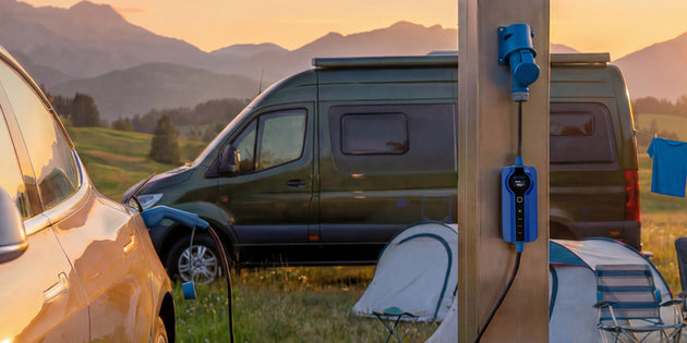 Electric campervan charging from a wooden campsite pillar with a blue CEE cable